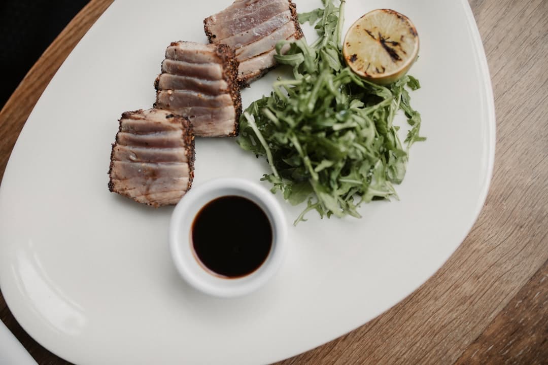 a white plate topped with meat and a salad - Master FSA regulations